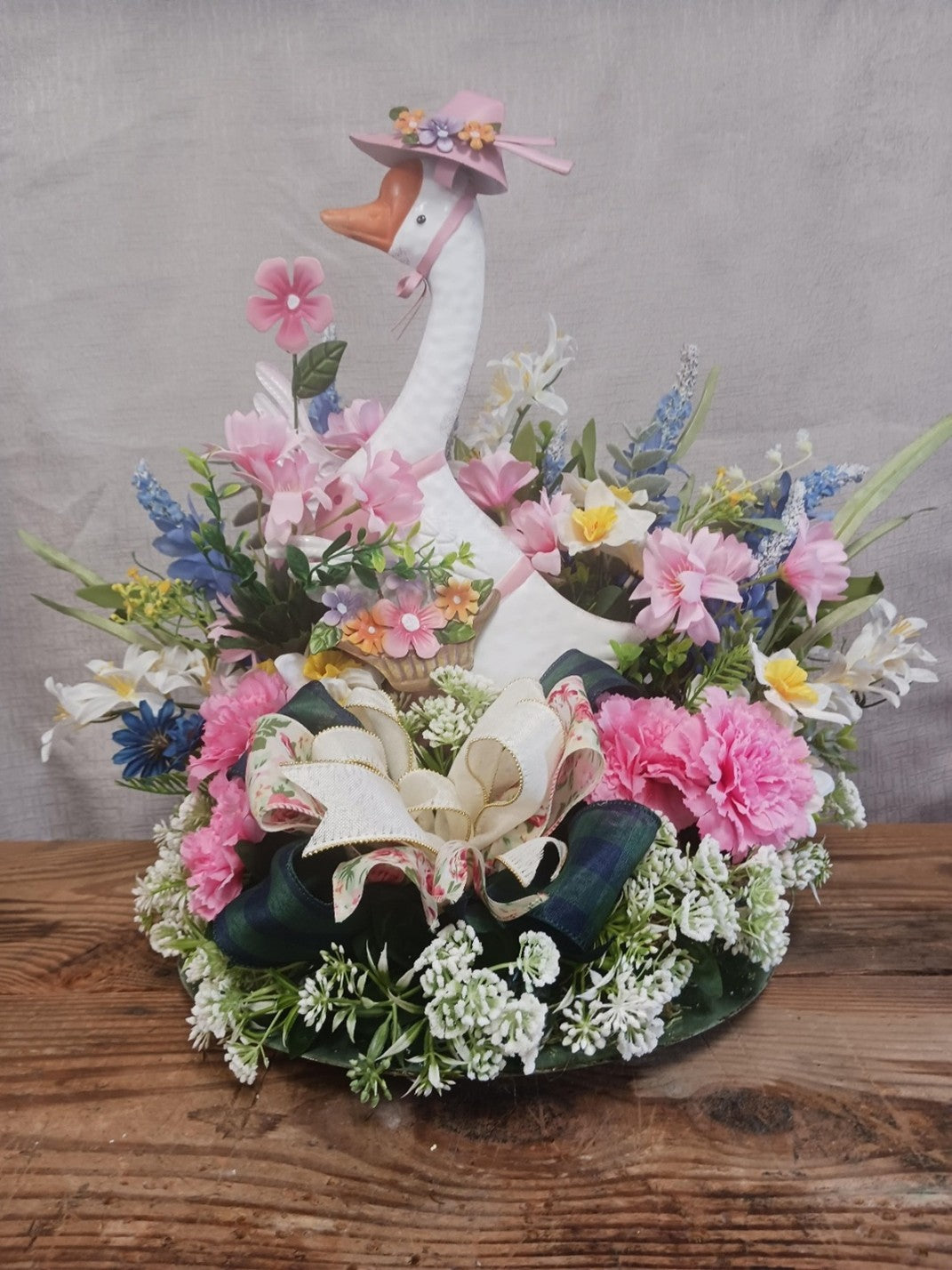 Beautiful Metal Goose in a Garden of Flowers